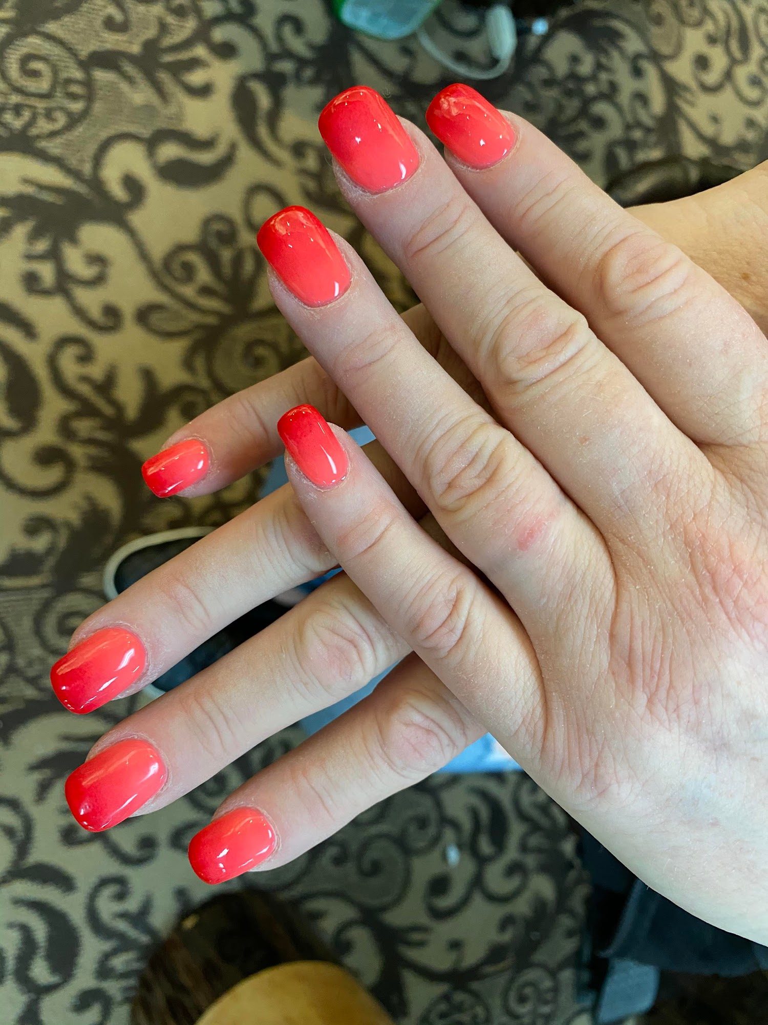 Short coral-red manicure.